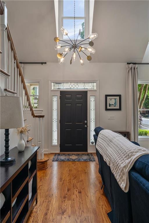1360 Edmund Ct NE, Atlanta, GA 30306 - entrance foyer with a chandelier, high vaulted ceiling, stairway, and wood finished floors