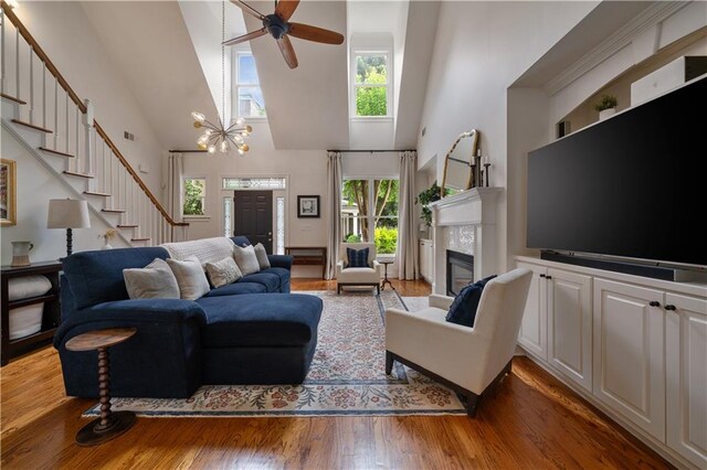 1360 Edmund Ct NE, Atlanta, GA 30306 - living area featuring high vaulted ceiling, stairs, light wood-style floors, a glass covered fireplace, and ceiling fan
