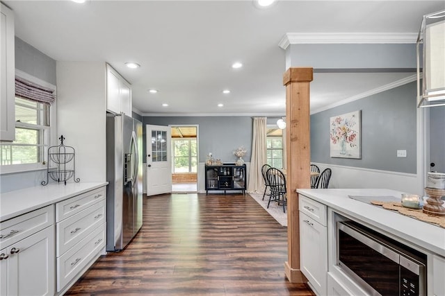 2653 Elkhart Cir SW, Marietta, GA 30064 - kitchen featuring stainless steel appliances, ornamental molding, dark wood-type flooring, light countertops, and white cabinets