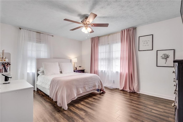 2653 Elkhart Cir SW, Marietta, GA 30064 - bedroom featuring dark wood-style floors, a ceiling fan, baseboards, and a textured ceiling