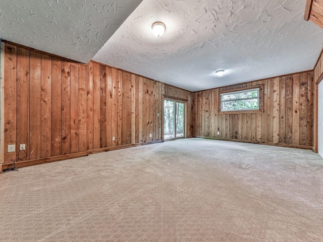 3771 Club Dr NW, Kennesaw, GA 30144 - carpeted spare room featuring wood walls, a textured ceiling, and baseboards