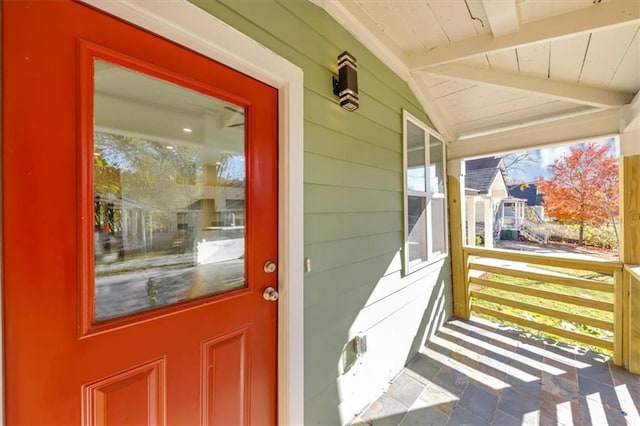 view of exterior entry with covered porch