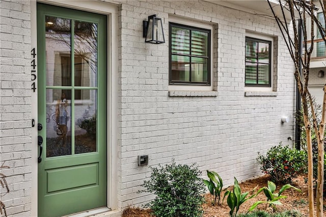 entrance to property with brick siding