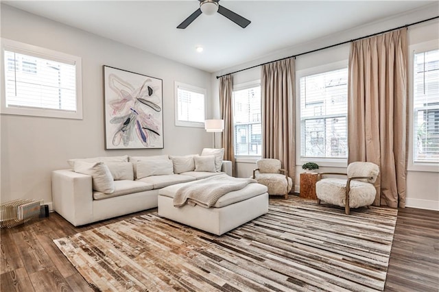 living area featuring ceiling fan, wood finished floors, and baseboards