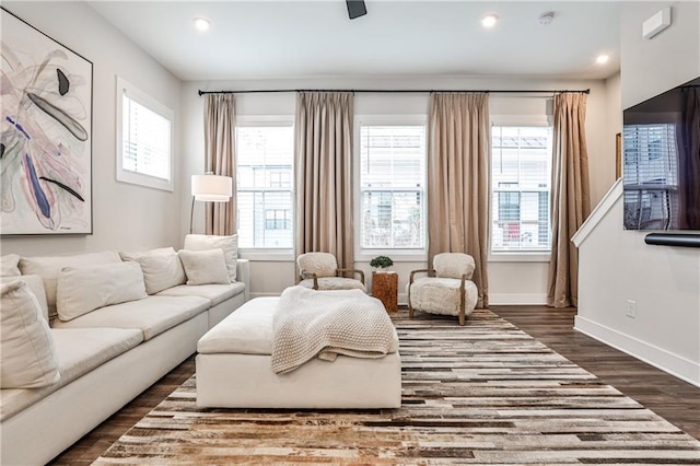 living room featuring recessed lighting, dark wood finished floors, and baseboards