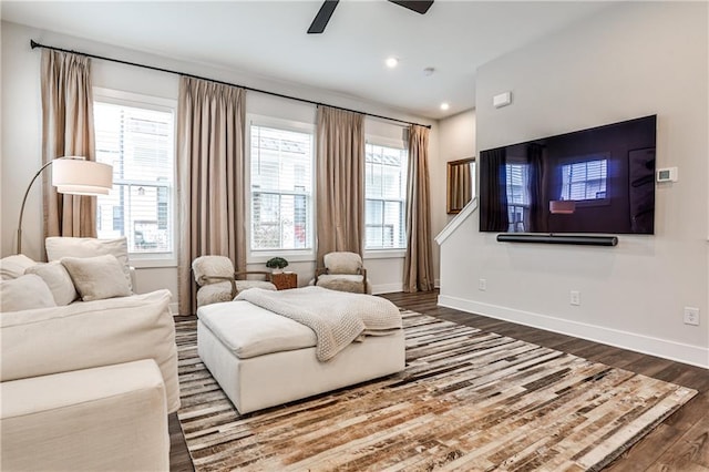 living area with recessed lighting, wood finished floors, a ceiling fan, and baseboards