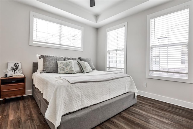 bedroom featuring a ceiling fan, baseboards, and dark wood-style flooring