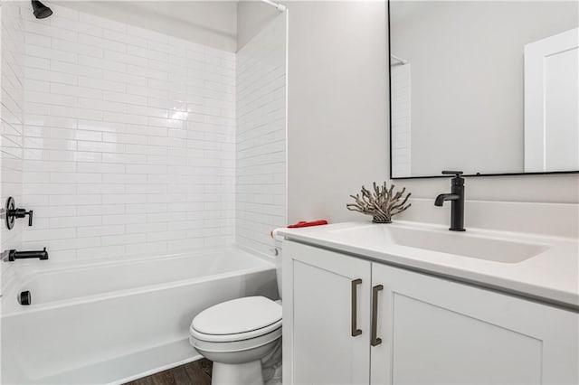 bathroom featuring toilet, washtub / shower combination, wood finished floors, and vanity