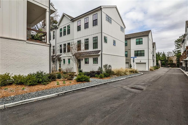 view of property with a garage and a residential view