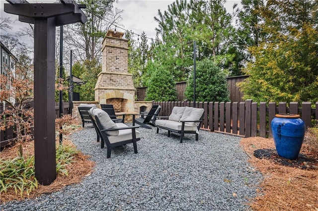 view of patio / terrace featuring an outdoor living space with a fireplace and fence