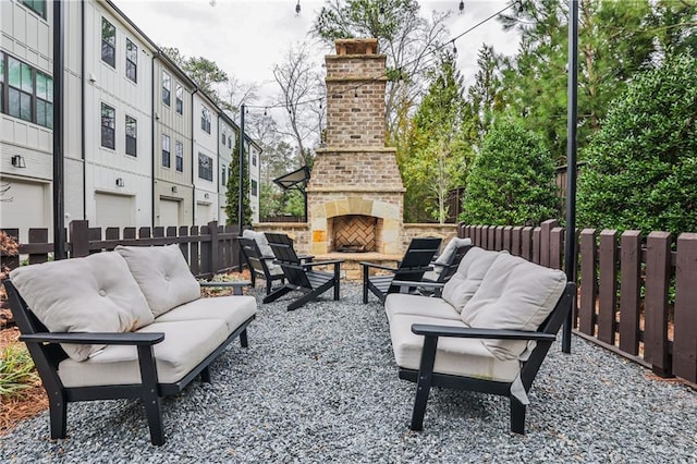 view of patio featuring fence and an outdoor living space with a fireplace