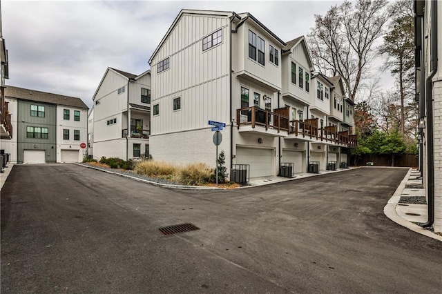 view of building exterior with a residential view and central AC