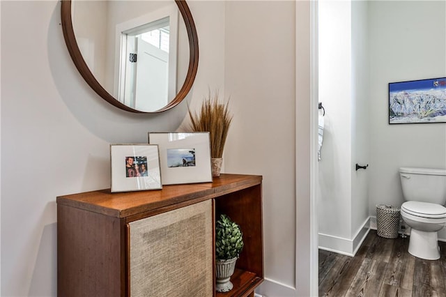 bathroom featuring baseboards, toilet, and wood finished floors