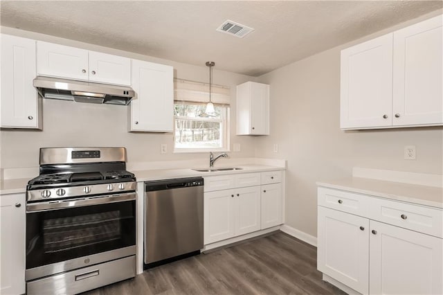 kitchen featuring sink, white cabinetry, pendant lighting, and appliances with stainless steel finishes