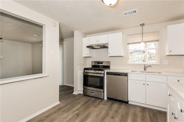 kitchen featuring sink, white cabinets, wood-type flooring, and stainless steel appliances