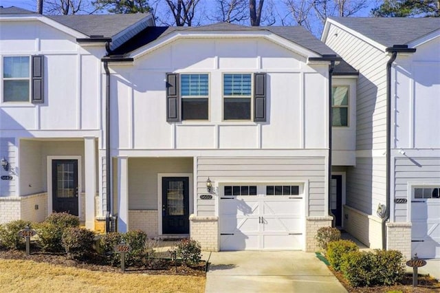 view of front of property with brick siding, driveway, and an attached garage