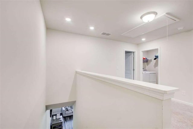 corridor featuring attic access, visible vents, carpet, washing machine and dryer, and recessed lighting