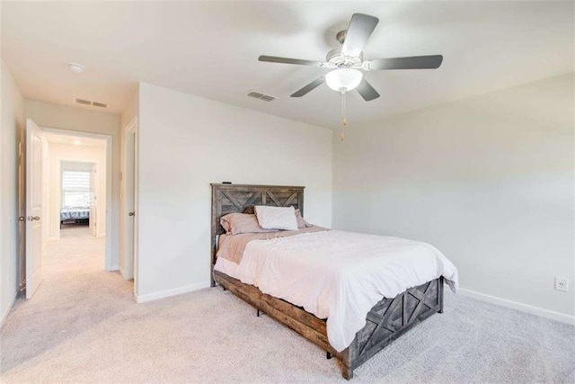 bedroom featuring visible vents, ceiling fan, light carpet, and baseboards