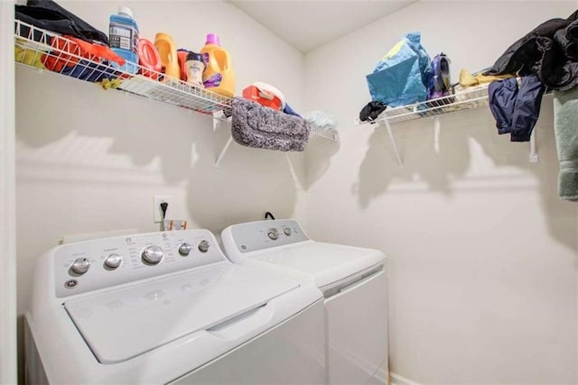 washroom with laundry area and independent washer and dryer