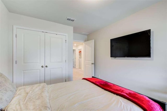 carpeted bedroom with a closet and visible vents