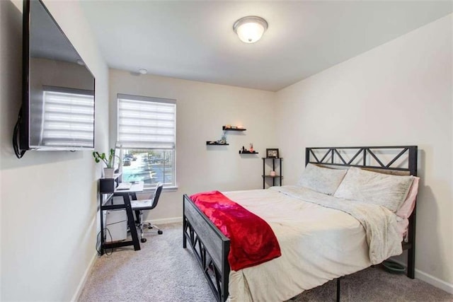 carpeted bedroom featuring baseboards