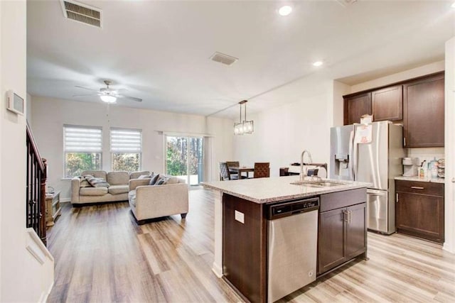 kitchen featuring dark brown cabinets, appliances with stainless steel finishes, and visible vents