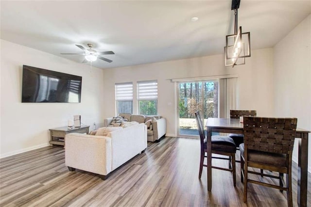 living room featuring ceiling fan, wood finished floors, and baseboards