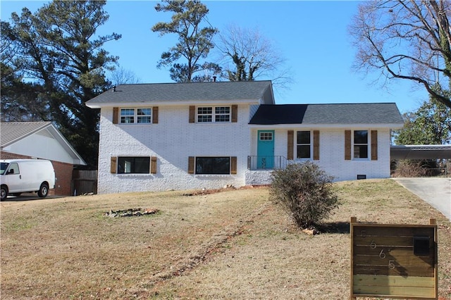 split level home featuring a front lawn