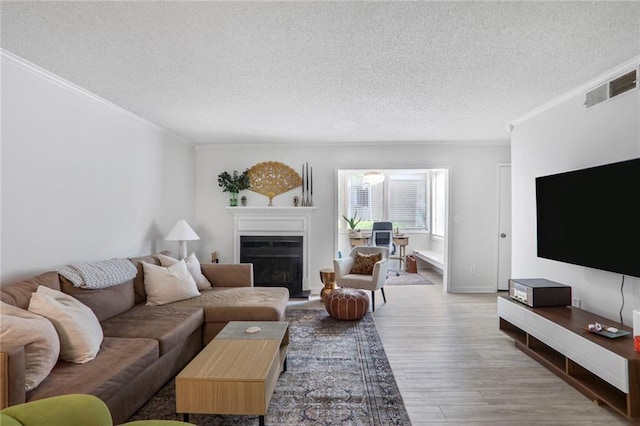 1303 Wingate Way, Atlanta, GA 30350 - living room featuring a textured ceiling, crown molding, wood finished floors, a fireplace, and baseboards