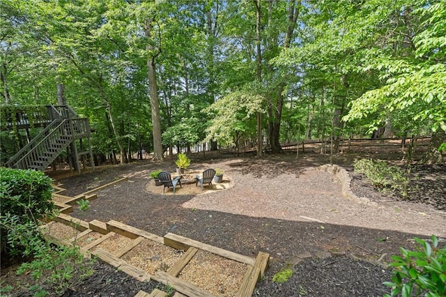 1755 Noblin Summit Dr, Duluth, GA 30097 - view of yard with a fire pit, stairway, a wooden deck, and view of scattered trees