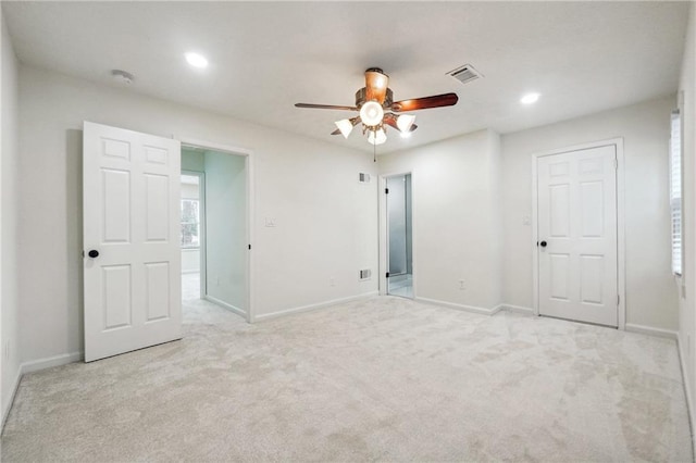 unfurnished bedroom with ceiling fan and light colored carpet