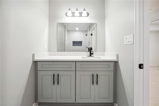 bathroom with vanity and a shower