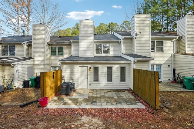 back of property with a patio area and central air condition unit