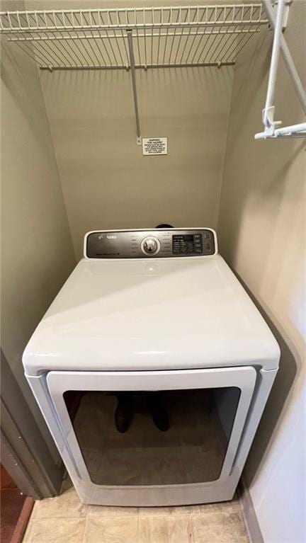 clothes washing area with washer / dryer