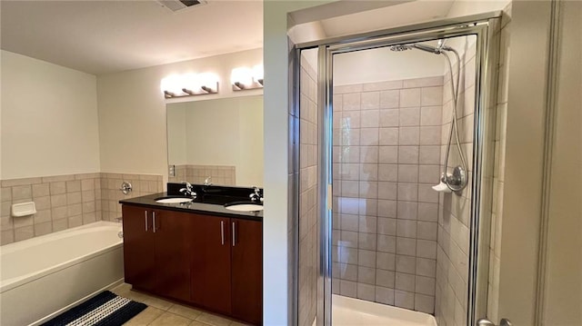 bathroom with tile patterned flooring, vanity, and shower with separate bathtub