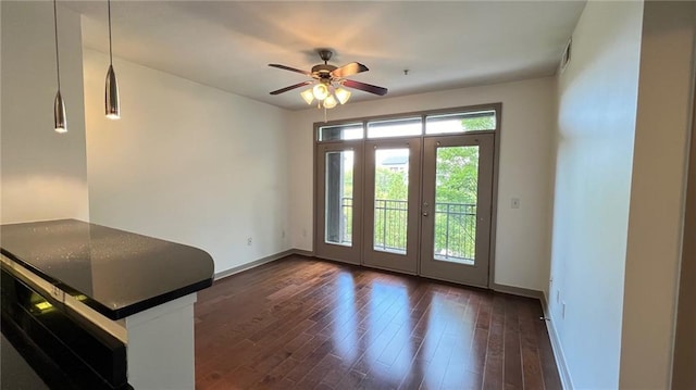 doorway with ceiling fan, dark wood-type flooring, and french doors