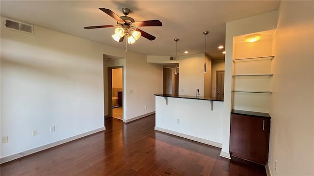 interior space featuring ceiling fan and dark hardwood / wood-style flooring