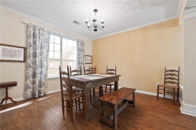 1065 Dalby Way, Austell, GA 30106 - dining room featuring dark wood-type flooring, a chandelier, a textured ceiling, baseboards, and crown molding