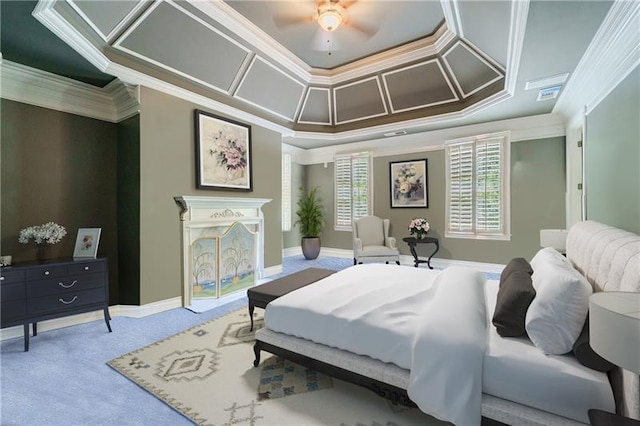 bedroom featuring ceiling fan, a tray ceiling, carpet floors, and ornamental molding