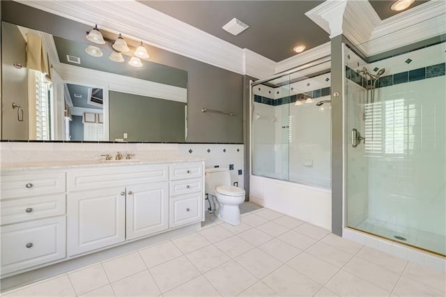 full bathroom featuring toilet, vanity, tile patterned floors, and crown molding