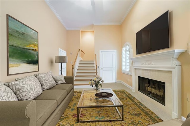 carpeted living room with ornamental molding and a fireplace