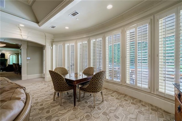 dining space with crown molding