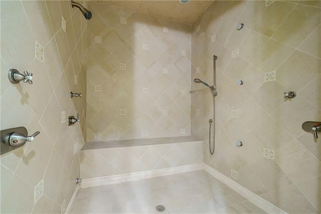 bathroom with a tile shower