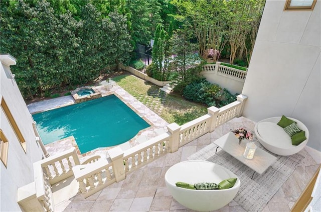 view of swimming pool featuring a patio area and an in ground hot tub