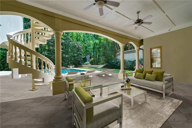 view of patio / terrace with ceiling fan and an outdoor living space