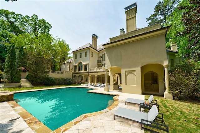 back of property with a patio area and a balcony