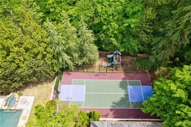 view of basketball court with tennis court and a playground