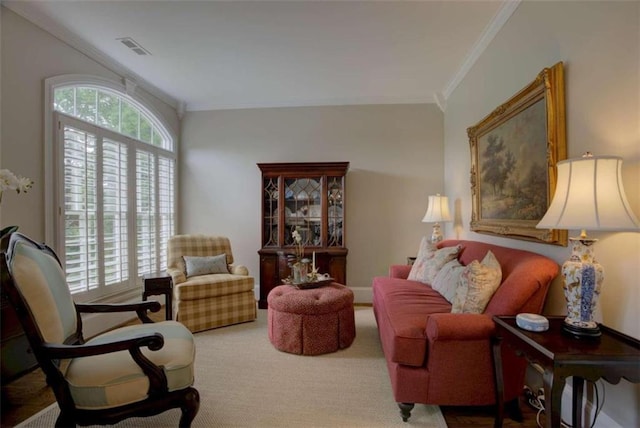 sitting room featuring ornamental molding and carpet flooring