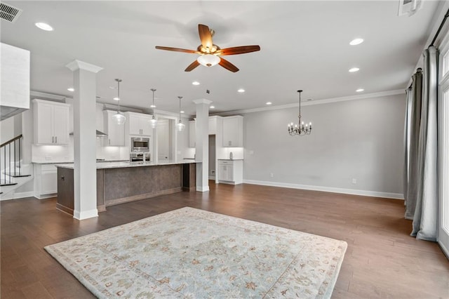 1858 Glenview Park Cir, Duluth, GA 30097 - unfurnished living room featuring a ceiling fan, crown molding, dark wood finished floors, recessed lighting, and a chandelier