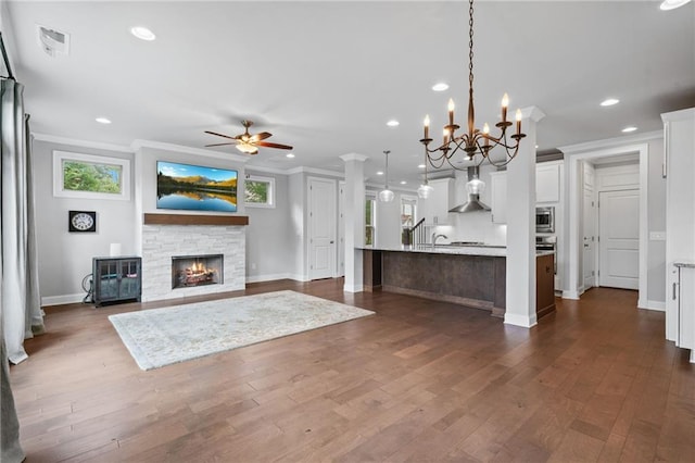 1858 Glenview Park Cir, Duluth, GA 30097 - kitchen featuring wall chimney range hood, stainless steel microwave, a ceiling fan, white cabinetry, and decorative light fixtures